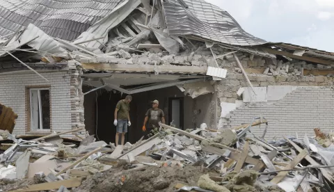 epa11545322 Locals clear debris following a rocket strike on a private building in a village near Brovary, Kyiv region, Ukraine, 11 August 2024, amid the Russian invasion. A man and his four-year-old son were killed while three other people were injured in an overnight Russian missile strike, the State Emergency Service of Ukraine said on 11 August. EPA/SERGEY DOLZHENKO 59898