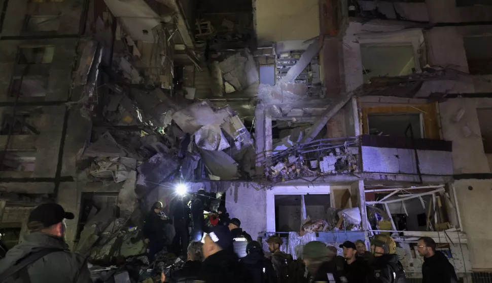 epa11693406 Ukrainian rescuers working at the site of a Russian glide-bomb attack late at night on a nine-flour residential building in Kharkiv, Ukraine, 30 October 2024 amid the ongoing Russian invasion. At least 29 people were injured and a child was killed, according to a post by head of Kharkiv Military Administration Oleg Synegubov on his telegram channel. EPA/SERGEY KOZLOV