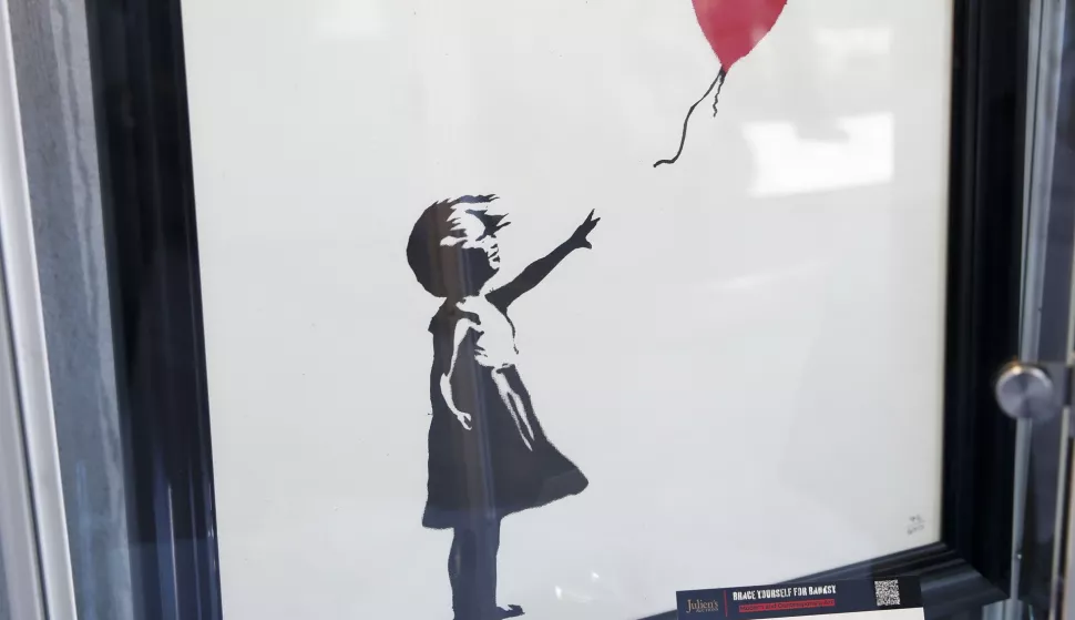 epa10546123 A limited-edition Banksy screenprint titled 'Girl With Balloon' is displayed during an auction preview titled 'Brace Yourself for Banksy: Modern and Contemporary Art' at Julien's Auctions Beverly Hills in Beverly Hills, California, USA, 27 March 2023. EPA/CAROLINE BREHMAN