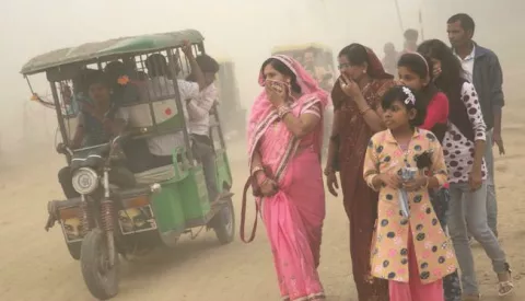 epa05619756 Indian pedestrians have their faces covered as they walk in heavy dust and smog in New Delhi, India, 06 November 2016. People in India's capital city are struggling with heavily polluted air after smoke released from fireworks set off during the Diwali celebrations last weekend still lingers in the air of the metropolis. The air has forced many local schools - especially those run by the government - to close for the day and the Delhi government put a ban on construction and demolition works for five days. Visibility in the city has been reduced to 400 meters as Delhi pollution levels rose to 15 times more then the safe limit, a news reports said. EPA/HARISH TYAGI