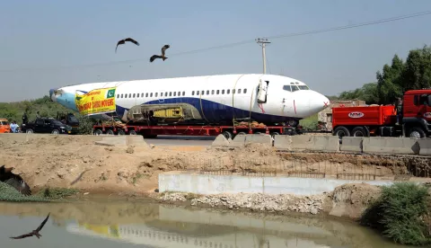 epa11695576 Workers transport a decommissioned Boeing 737 in Hyderabad, Pakistan, 01 November 2024. The decommissioned Boeing 737, retired in Karachi in 2014 after over two decades of service, was transported by road from Karachi to Hyderabad for training purposes. The journey, managed by New Babar Cargo Movers, involves dismantling the aircraft's wings, engines, and wheels for safe travel on the M-9 Motorway, with the plane being moved at a cautious speed of 20 to 30 kilometers per hour. EPA/NADEEM KHAWAR