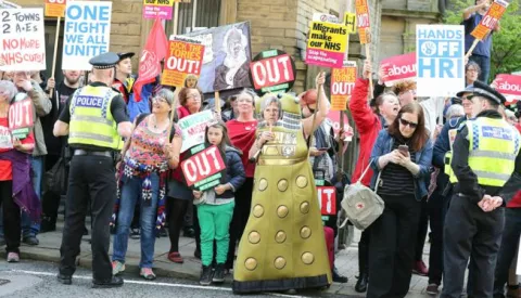 epa05972008 Protestors react ahead of the arrival of British Prime Minister Theresa May and leader of the British Conservative party to launch their manifesto at The Arches in Halifax, north west England on 18 May 2017. British Prime Minister Theresa May has called a snap general election for 08 June 2017. EPA/NIGEL RODDIS