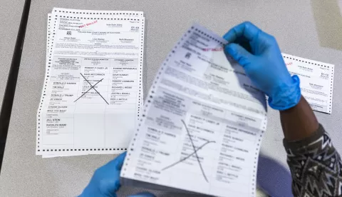 epa11683682 An election worker uses test ballots to demonstrate how ballots for the 2024 presidential election will be flattened for easier scanning at an elections warehouse in Philadelphia, Pennsylvania, USA, 25 October 2024. Pennsylvania is one of seven states that forbids election workers from processing mail-in ballots before 7am on Election Day. That controversial state law means it will likely take Pennsylvania days to tabulate its presidential election results. EPA/JIM LO SCALZO