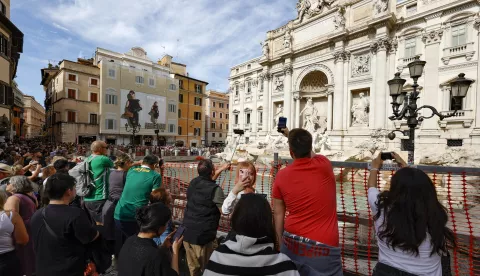 epa11650519 Tourists visit the Fontana di Trevi (Trevi Fountain), as it is cordoned due to the start of maintenance work, in Rome, Italy, 09 October 2024. According to the mayor of Rome, maintenance works, supervised by the Capitoline Superintendency, are expected to last until the end of the year. He also added that Trevi Fountain access would be limited during the Roman Catholic Jubilee Holy Year of 2025 as part of a pilot scheme that may introduce a fee. EPA/FABIO FRUSTACI