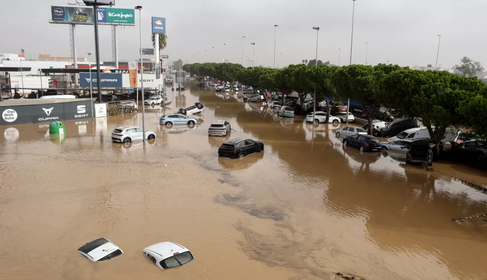 epa11692162 Damaged vehicles lie amidst flood waters at an industrial complex in Sedavi, in the province of Valencia, eastern Spain, 30 October 2024. The intense rainfall impacting the eastern part of the country resulted in at least 62 lives being lost in the province of Valencia due to the flooding. The State Meteorological Agency (AEMET) has issued red alerts for rainfall in multiple regions of the province of Valencia, caused by the severe storm DANA. EPA/MIGUEL ANGEL POLO