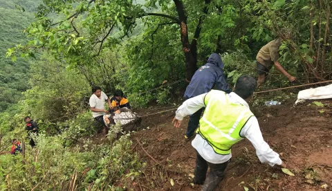 epa06915659 Rescuers work at the site where a bus carrying some 40 passengers fell into valley near Poladpur in Raigad district of Maharashtra, India, 28 July 2018. According to reports, more than 30 people feared to death after a bus carrying staff members of Dapoli Agriculture University slipped off the road and fell into a valley near Poladpur in Raigad district, some 200 kilometres from Mumbai. EPA/STR BEST QUALITY AVAILABLE