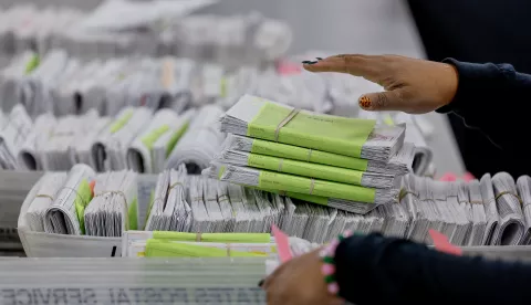 epa11701434 A worker with the Fulton County Department of Registration & Elections sorts through voter registration forms at the county's new Elections Hub and Operations Center in Union City, Georgia, USA, 04 November 2024. Officials gave the news media a tour of the site, one day ahead of the US Election Day, 05 November 2024. EPA/ERIK S. LESSER