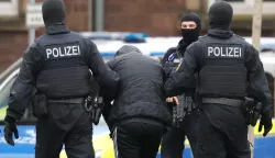 epa11671134 Federal Police officers lead the arrested Libyan suspect Omar A. (C) from a helicopter for his arraignment at the Federal Supreme Court (BGH) in Karlsruhe, Germany, 20 October 2024. According to the Federal Public Prosecutor General's Office, Omar A. is a supporter of the terrorist organization IS. Since October 2024, he intended to carry out a high-profile attack with firearms on the Israeli Embassy in Berlin. To plan the attack, the accused exchanged information with a member of the IS via a messenger chat. EPA/RONALD WITTEK