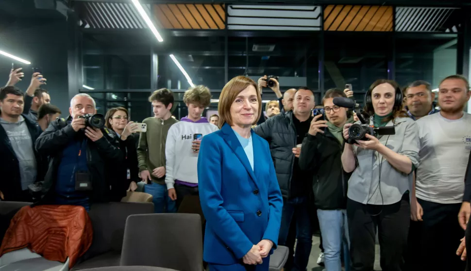 epa11699969 The incumbent President of Moldova Maia Sandu flanked by her supporters following the announcement of the preliminary election results at her campaign headquarters in Chisinau, Moldova, 03 November 2024. Moldova is holding the second round of presidential elections, with former Attorney General of Moldova Alexandr Stoianoglo facing incumbent President of Moldova Maia Sandu. EPA/DUMITRU DORU