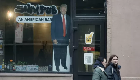 epa11710111 Pedestrians walk past a cardboard depicting US president-elect Donald J. Trump, displayed in the window of a US bar in St. Petersburg, Russia, 08 November 2024. US Republican presidential candidate Donald J. Trump has been elected the 47th president of the United States after having secured more than the 270 Electoral College votes necessary, following a tightly contested race with Democratic presidential candidate US Vice President Kamala Harris. EPA/ANATOLY MALTSEV