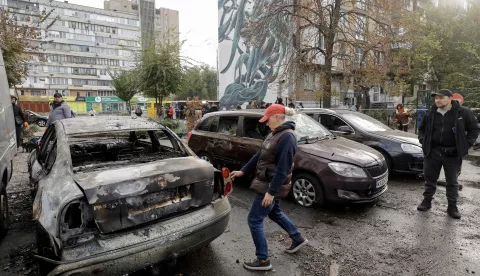 epa11690143 People inspect damaged cars following an overnight drone attack on a residential building in Kyiv, Ukraine, 29 October 2024, amid the ongoing Russian invasion. At least six persons were injured after debris fell as a result of a drone attack on a residential area of Kyiv, the State Emergency Service of Ukraine (SESU) reported. Russian troops launched an overnight attack with 48 'Shahed' unmanned aerial vehicles (UAV) across Ukraine, the Ukrainian Armed Forces said. Russian troops entered Ukrainian territory on 24 February 2022, starting a conflict that has provoked destruction and a humanitarian crisis. EPA/SERGEY DOLZHENKO