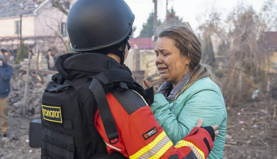 epa11725387 A handout photo released by the press service of the State Emergency Service (SES) of Ukraine shows a Ukrainian psychologist assisting a woman near the site of an air strike in Odesa, southwestern Ukraine, 17 November 2024. Russian forces launched a 'massive combined attack that targeted all regions of Ukraine' overnight and in the morning with around 120 missiles and 90 unmanned aerial vehicles (UAVs), Ukrainian President Zelensky said on 17 November, adding that Ukraine's air defense forces destroyed more than 140 air targets. The main target of the Russian attack was the energy infrastructure across Ukraine, Zelensky said. Russian troops entered Ukrainian territory on 24 February 2022, starting a conflict that has provoked destruction and a humanitarian crisis. EPA/STATE EMERGENCY SERVICE OF UKRAINE HANDOUT -- BEST QUALITY AVAILABLE -- MANDATORY CREDIT: STATE EMERGENCY SERVICE OF UKRAINE -- HANDOUT EDITORIAL USE ONLY/NO SALES