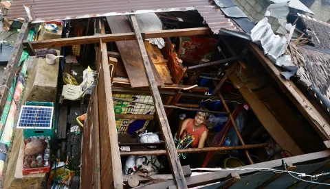 epaselect epa11726685 An elderly villager woman collects belongings inside a damaged home in the typhoon-hit municipality of Baler, Aurora province, Philippines, 18 November 2024. Local government units in typhoon Man-yi's path from Bicol region to Luzon region conducted pre-emptive evacuation of citizens to safeguard against floods and strong winds. EPA/FRANCIS R. MALASIG