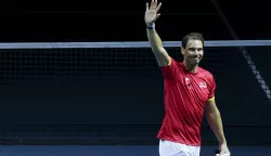 epa11730106 Rafa Nadal of Spain waves during a tribute received after the Spanish doubles match against the Netherlands during the Davis Cup quarterfinal between Netherlands and Spain at the Jose Maria Martin Carpena Sports Palace in Malaga, Spain, 19 November 2024. EPA/JORGE ZAPATA