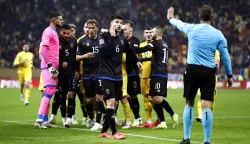 epa11723613 Players of Kosovo (in black) gather to leave the pitch after a group of supporters chanted pro Serbia chants before the end of the UEFA Nations League soccer match between Romania and Kosovo, in Bucharest, Romania, 15 November 2024. EPA/ROBERT GHEMENT