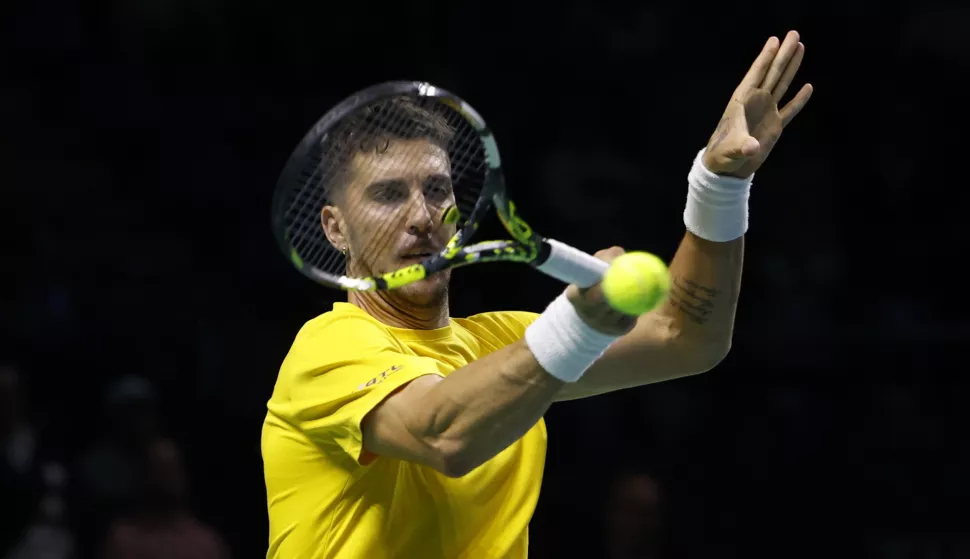 epa11732572 Australian tennis player Thanasi Kokkinakis in action against US Ben Shelton during the Davis Cup quarterfinals games between the USA and Australia played at the Jose Maria Martin Carpena Pavilion in Malaga, Spain, 21 November 2024. EPA/Jorge Zapata