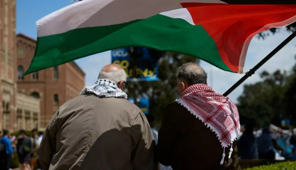 epa11301414 Two men wave the Palestinian flag as University of California Los Angeles (UCLA) students set up a Gaza solidarity encampment on campus to advocate for Palestine in Los Angeles, California, USA, 25 April 2024. More than 34,000 Palestinians and over 1,450 Israelis have been killed, according to the Palestinian Health Ministry and the Israel Defense Forces (IDF), since Hamas militants launched an attack against Israel from the Gaza Strip on 07 October 2023, and the Israeli operations in Gaza and the West Bank which followed it. EPA/ALLISON DINNER