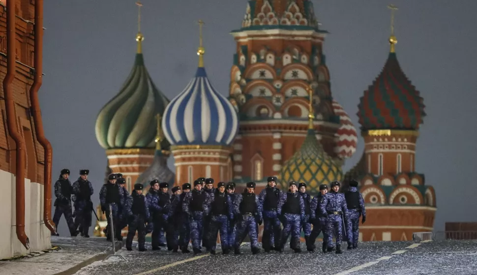 epa11051177 Police officers patrol the Red Square in Moscow (Moskva), Russia, late 31 December 2023. Fireworks displays on New Year's Eve and Christmas have been canceled in Moscow. Red Square closed to visitors from 6:00 pm on 31 December 2023 to 8:00 am on 01 January 2024. Security measures will be strengthened in the center of the capital. The restrictions are related to a special military operation in Ukraine, the authorities clarified. Deputies of the State Duma suggested that Moscow Mayor Sergei Sobyanin give up New Year's fireworks and use the money saved to help the front. Moscow residents supported this decision at the vote. EPA/YURI KOCHETKOV