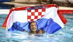 epa06116756 Loren Fatovic of Croatia celebrates with the Croatian national flag after his team won the men's water polo final match Hungary vs Croatia at the 17th FINA Swimming World Championships in Hajos Alfred National Swimming Pool in Budapest, Hungary, 29 July 2017. EPA/SZILARD KOSZTICSAK HUNGARY OUT