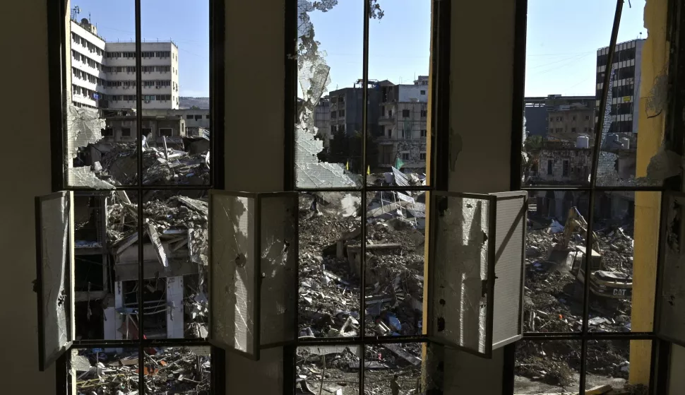 epa11745425 An excavator cleans the debris at a damaged building as displaced residents return to Nabatieh following a ceasefire deal between Israel and Hezbollah, in southern Lebanon, 28 November 2024. The 60-day ceasefire came into force on 27 November. EPA/WAEL HAMZEH