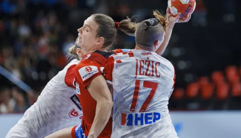 epa11748472 Helene Elver (C) of Denmark and Katarina Jezic (R) of Croatia in action during the EHF Women's EURO 2024 preliminary round handball match between Denmark and Croatia, in Basel, Switzerland, 29 November 2024. EPA/Liselotte Sabroe DENMARK OUT