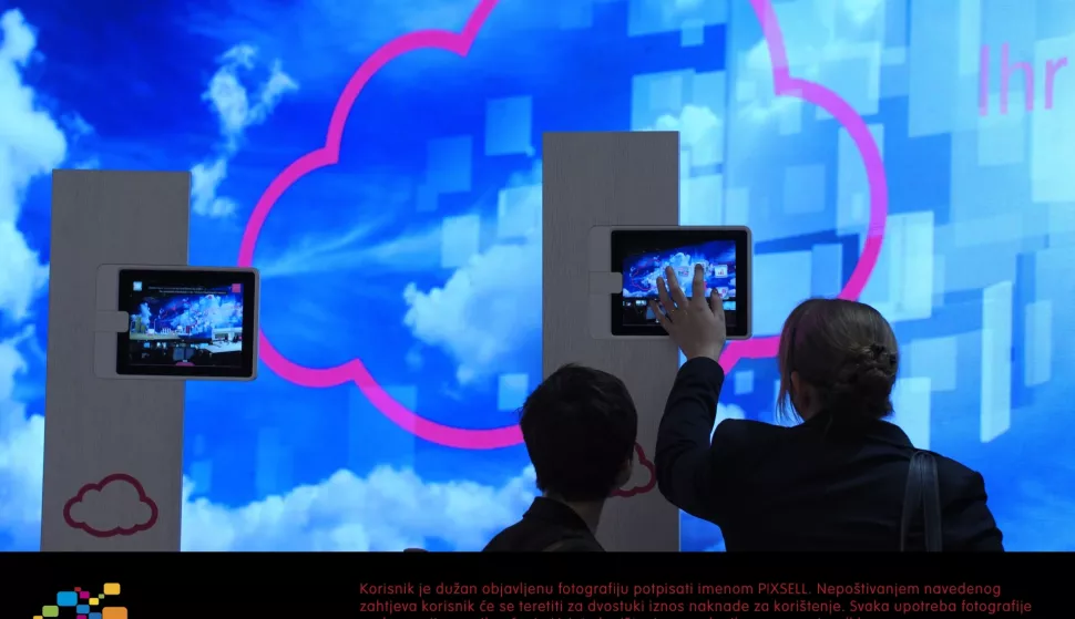 Visitors look at an installation at the deutsche telekom stand at the CeBIT in Hanover, Germany, 08 March 2012. From 06 to 10 March 2012, more than 4,200 companies from 70 countries will present their products at the world's biggest computer trade show CeBIT 2012. Photo: Peter Steffen/DPA/PIXSELL