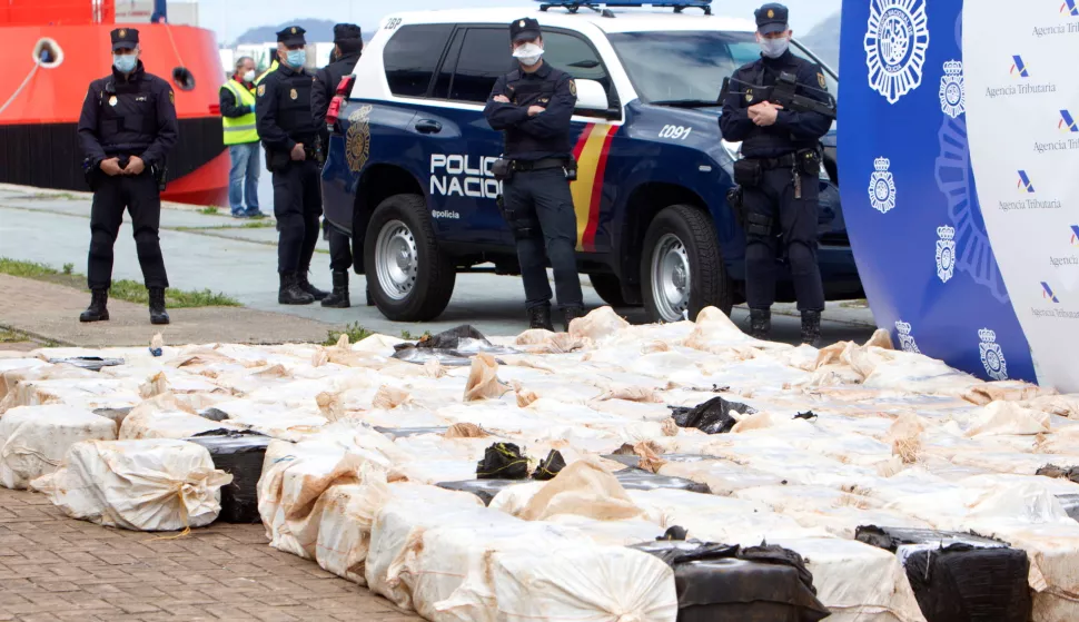 epa08389034 Policemen stand next to several bundles of cocaine during a press conference in Vigo, northwestern Spain, 28 April 2020. Security forces seized 4 tons of cocaine and arrested some 28 people, during a raid to disband a 'narco-carrier' network. EPA/SALVADOR SAS