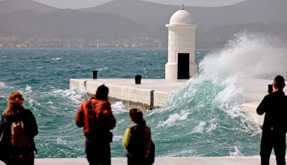 Zadar, 30.03.2024. - Radi jakog juga koje puse na zadarskom području u prekidu su brojne brodske i katamaranske linije prema zadarskim otocima. Kao i bično kad puše jako jugo najzanimljivije turistima i Zadranima bilo je na rivi.Foto HINA/Zvonko KUCELIN