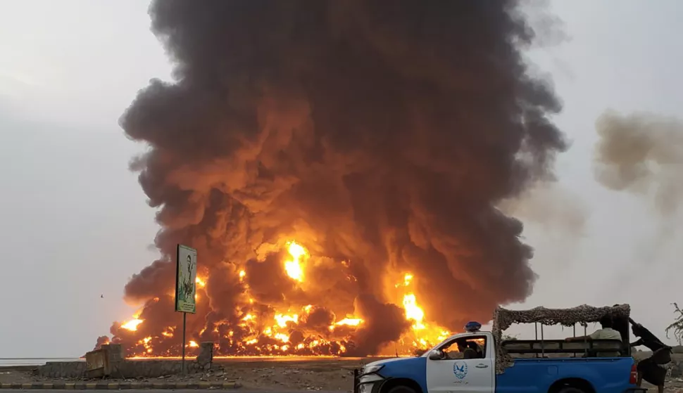 epa11489551 A handout screen grab taken from a video released by the Houthis media center shows a Houthi police car driving past fire and smoke rising following Israeli airstrikes in the port city of Hodeidah, Yemen, 20 July 2024. The Israel Defense Forces (IDF) confirmed on 20 July to have carried out airstrikes on Houthi military targets in the area of the Hodeidah port. Houthis-run TV station Al Masirah reported that the Israeli strikes targeted the Ras Kathnib power station and fuel tanks. The airstrikes come a day after the Houthis launched a drone attack on Tel Aviv, killing one and wounding at least 10 more. EPA/HOUTHIS MEDIA CENTER/HANDOUT BEST QUALITY AVAILABLEHANDOUT EDITORIAL USE ONLY/NO SALES