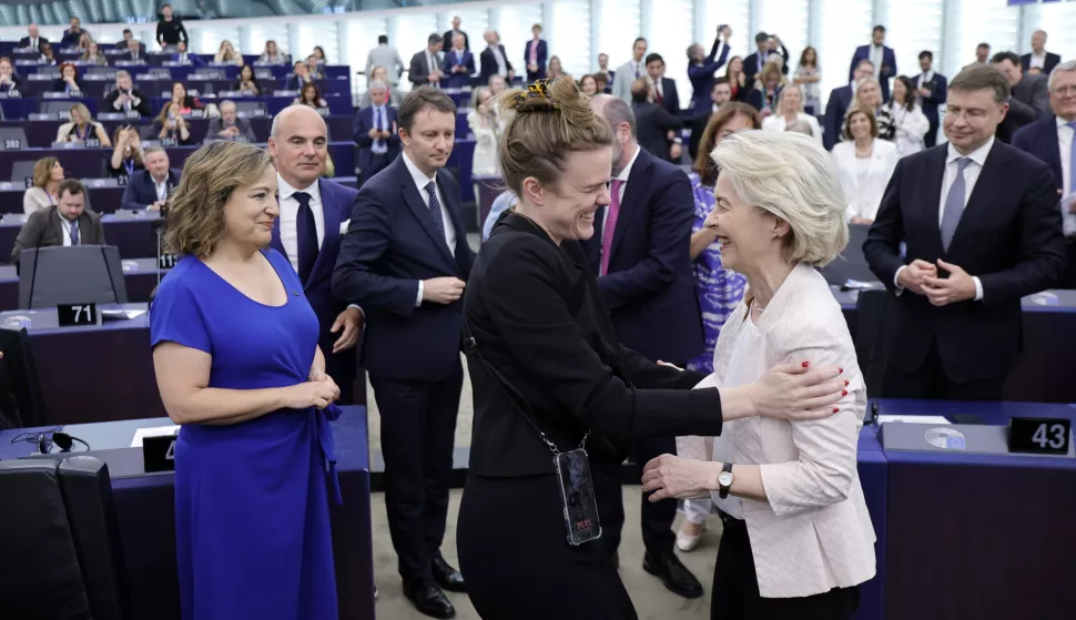 epa11485379 Ursula von der Leyen (R) is congratuladed by German MEP Theresa Reintke (C) as Leader of the Progressive Alliance of Socialists and Democrats (S&D) parliamentary group, Iratxe Garcia Perez (L) looks on after being re-elected as European Commission President during a plenary session of the European Parliament in Strasbourg, France, 18 July 2024. MEPs re-elected Von der Leyen as European Commission President for the next five years. EPA/RONALD WITTEK