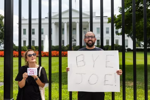 epa11490798 Michael Wille (R) holds a sign outside the White House after US President Joe Biden dropped out of the 2024 presidential race in Washington, DC, USA, 21 July 2024. Joe Bidenon 21 July announced on his X (formerly Twitter) account that he would not seek re-election in November 2024, and endorsed Harris to be the Democrats' new nominee. EPA/JIM LO SCALZO