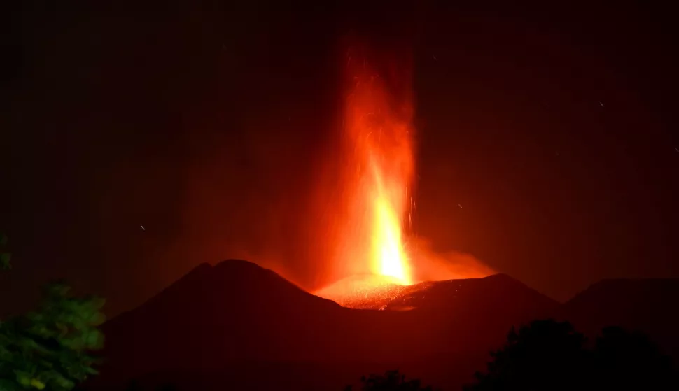 epa11480941 The Mount Etna volcano spews lava during an eruption in Sicily island, Italy, 15 July 2024 (issued 16 July 2024). Mount Etna's Voragine crater spewed lava through the night, with a column of ash that reached an altitude of about 6,000 meters above sea level. EPA/ORIETTA SCARDINO