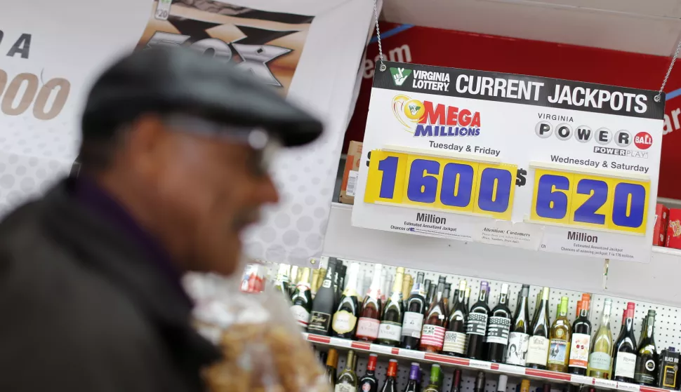 epa07111561 A sign shows the current Mega Millions and Powerball lottery jackpots as a customer purchases Mega Millions lottery tickets at a retailer in Arlington, Virginia, USA, 22 October 2018. No winning tickets were sold for 19 October's Mega Millions drawing, a 44-state lottery, and the jackpot now grows to 1.6 billion US dollars for the next drawing on 23 October 2018. EPA/ERIK S. LESSER