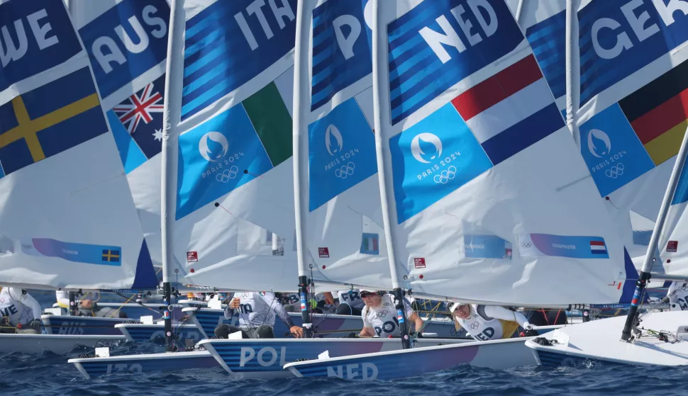 epa11528226 Marit Bouwmeester of the Netherlands (R) in action to win the gold medal of the Women Dinghy ILCA 6 at the Sailing competitions in the Paris 2024 Olympic Games, at the Marseille Marina in Marseille, France, 05 August 2024. EPA/OLIVIER HOSLET