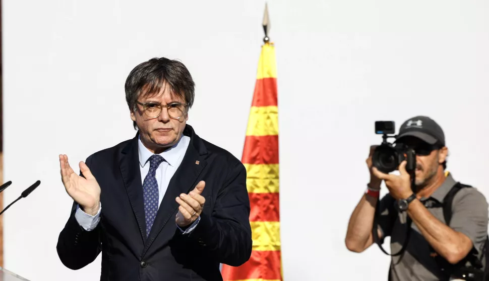 epa11535505 Former Catalan president Carles Puigdemont (L) gestures as he addresses supporters in Barcelona, Spain, 08 August 2024. Catalonia's former president Carles Puigdemont returned to Spain after seven years of self-imposed exile abroad, despite a pending arrest warrant. The Mossos d'Esquadra was deployed early morning on 08 August to secure access to the Parliament for the investiture of Salvador Illa. The plenary session of the Parliament will host the investiture debate of the Socialist leader Salvador Illa as the new president of the Generalitat, the government of Catalonia. EPA/ALBERTO ESTEVEZ