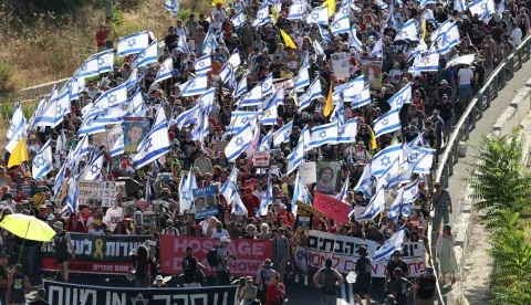 epaselect epa11476157 Relatives and family members of Israeli hostages held by Hamas in Gaza and their supporters hold placards, banners and flags as they take part in a protest march calling for the release of the hostages, as they walk on a road leading to Jerusalem, 13 July 2024. Some hostage families began a four-day march toward Jerusalem where they plan to stage a rally at the Israeli prime minister's office. According to the Israeli military, 116 Israelis, who were abducted and taken to the Gaza Strip during the 07 October 2023 attacks by Hamas, remain in captivity. Rallies in Israel have been critical of the government's handling of the crisis, demanding the immediate release of all hostages. EPA/ABIR SULTAN