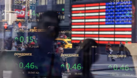 epa11549022 Stock prices are listed on a screen as seen through the window at the Nasdaq MarketSite in New York, New York, USA, 14 August 2024. US stocks, including Dow Jones Industrial Average, went up on 14 August after the release of US inflation data. The Consumer Price Index cooled to 2.9 percent in July 2024, down from 3 percent in June, the Bureau of Labor Statistics reported on 14 August. EPA/SARAH YENESEL