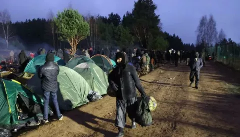 epa09588732 A handout photo made available by BelTA shows people at a camp at the Belarusian-Polish border near the Bruzgi-Kuznica Bialostocka border crossing, in the Grodno region, Belarus, 18 November 2021. Asylum-seekers, refugees and migrants from the Middle East arrived at the Belarusian-Polish checkpoint of Bruzgi-Kuznica aiming to cross the border. Thousands people who want to obtain asylum in the European Union have been trapped at low temperatures at the border since 08 November. EPA/MAXIM GUCHEK/BELTA HANDOUT -- MANDATORY CREDIT -- HANDOUT EDITORIAL USE ONLY/NO SALES