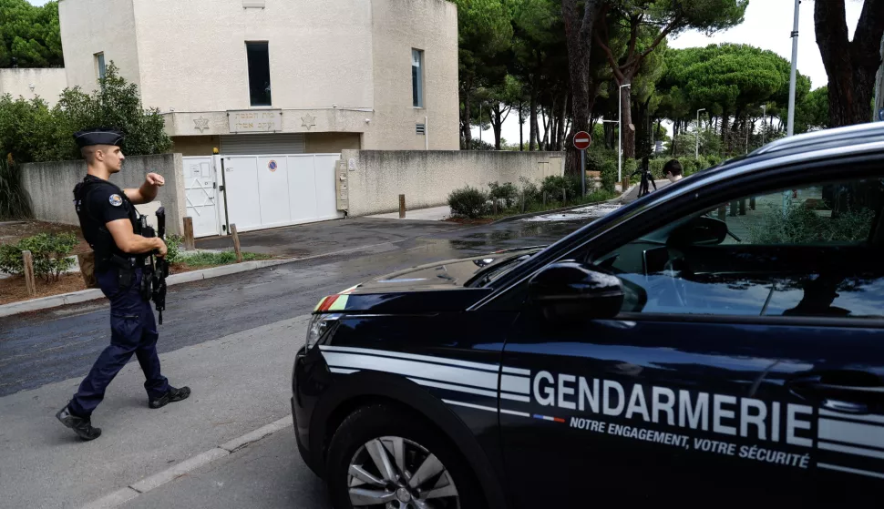 epa11563929 French police officers stand in front of the Beth Yaacov synagogue the day after an explosion occured outside, in La Grande-Motte, southern France, 25 August 2024. A police officer was injured in an explosion after two vehicles were set alight outside a synagogue in La Grande-Motte on the morning of 24 August, according to the police. 'The alleged perpetrator' was detained on 24 August, French Interior Minister Gerald Darmanin said. EPA/SEBASTIEN NOGIER