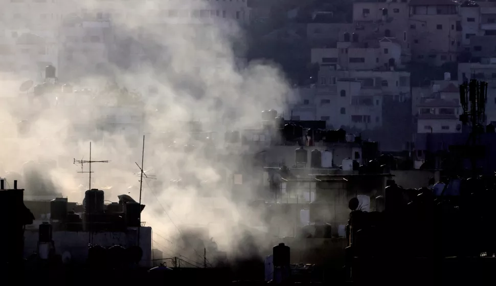 epa11575946 Smokes rises over Jenin camp during heavy clashes on the fourth day of an Israeli military operation in the West Bank city of Jenin, 31 August 2024. According to the Palestinian Health Ministry, at least 20 Palestinians have been killed since Israeli military operations started on 28 August 2024 in the West Bank cities of Tulkarem, Jenin and Tubas. The Israeli army said that it's conducting a large-scale 'counter-terrorism operation' in several areas. EPA/ALAA BADARNEH