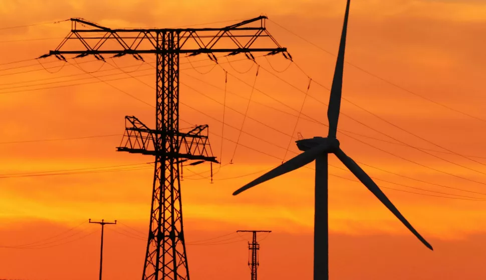 FILE - A file picture from 24 July 2012 shows a wind turbine near a high-tension power line at sunset near Rehna, Germany. Photo: Jens B?ttner/dpa-Zentralbild/dpa /DPA/PIXSELL