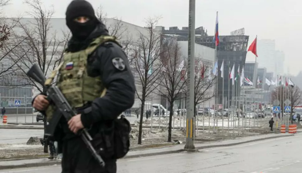 epa11238296 A Russian policeman guards near the burned Crocus City Hall concert venue following a terrorist attack in Krasnogorsk, outside Moscow, Russia, 23 March 2024. On 22 March evening, a group of up to five gunmen attacked the Crocus City Hall in the Moscow region, Russian emergency services said. 93 people were killed and more than 100 others were hospitalized, the Investigative Committee confirmed. The head of the Russian FSB, Alexander Bortnikov, reported to Russian President Vladimir Putin on 23 March on the arrest of 11 people, including all four terrorists directly involved in the terrorist attack. EPA/MAXIM SHIPENKOV