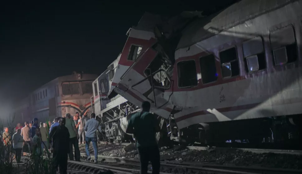 epa11604753 Local residents and rescuers gather at the site where two trains collided, in the city of Zagazig, Sharqiya governorate, Egypt, 14 September 2024. At least three people died and 47 others injured on 14 September after two trains collided in the Sharqiya governorate, north of Cairo, according to a statement by the country's ministry of health. EPA/AHMED ELBAGRA