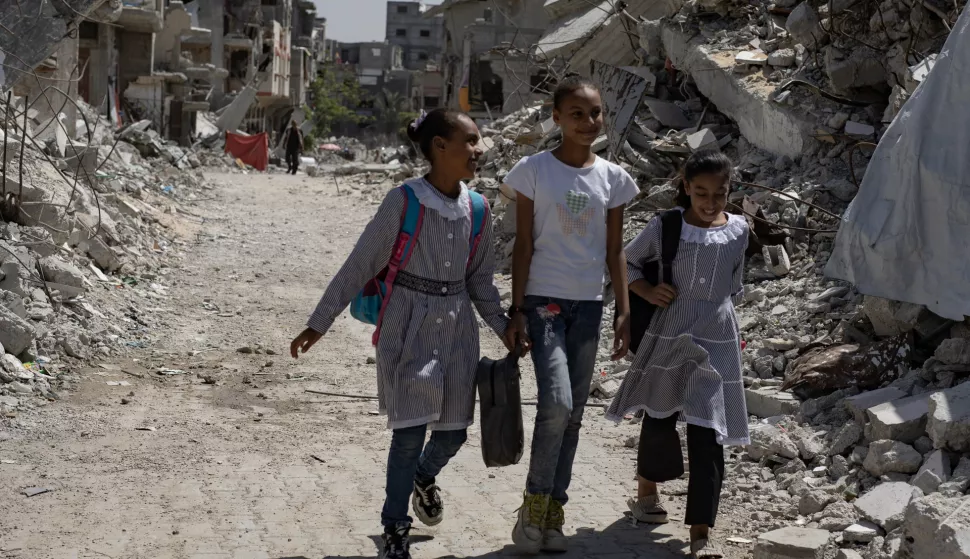 epa11599975 Palestinian children walk past destroyed buildings as they head to class in the Khan Younis camp, southern Gaza Strip, 12 September 2024. Palestinian teacher Israa Abu Mustafa (not pictured) set up a makeshift classroom in a tent built on the rubble of her old house. According to a statement released by the Palestinian Ministry of Education, more than 650,000 students in the Gaza Strip are being deprived of their right to education for the second academic year in a row. At least 84 percent of schools in the Gaza Strip 'require full reconstruction or significant rehabilitation before schooling can resume', the United Nations Children's Fund (UNICEF) reported in September 2024. More than 41,000 Palestinians and over 1,400 Israelis have been killed, according to the Palestinian Health Ministry and the Israel Defense Forces (IDF), since Hamas militants launched an attack against Israel from the Gaza Strip on 07 October 2023, and the Israeli operations in Gaza and the West Bank which followed it. EPA/HAITHAM IMAD