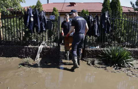 epa11608163 Romanian emergency rescuers carry furniture outside a flooded school in the flood-affected village of Pechea, near Galati city, Romania, 16 September 2024. At least seven people died in the Galati area, with about 10,000 homes damaged over 2,000 households still disconnected from the electricity grid as a result of flooding caused by heavy rains brought by Cyclone Boris. EPA/ROBERT GHEMENT