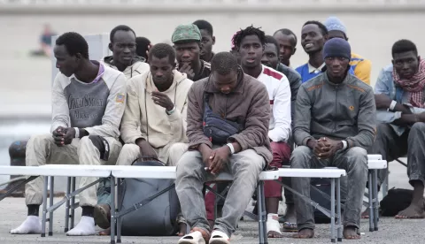 epa11613593 Rescued migrants rest after arriving to the port of Los Cristianos, in Tenerife, Canary Island, Spain, 19 September 2024. Maritime Rescue has escorted a cayuco with 64 migrants on board, 52 were adults and 12 were minors. EPA/ALBERTO VALDES