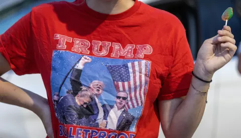 epa11606996 A supporter of former President Donald Trump stands near his Mar-a-Lago residence in West Palm Beach, Florida, USA on 15 September 2024. According to the FBI, they are following an investigation of what appears to be an attempted assassination of Former President Donald Trump. Palm Beach County Sheriff Ric Bradshaw said the US Secret Service agents found a man pointing an AK-style rifle with a scope into the club as Trump was on the course. EPA/CRISTOBAL HERRERA-ULASHKEVICH