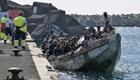 epa11619725 A small wooden boat ('cayuco') carrying some of the 127 sub-Saharan migrants that have been rescued by search & rescue vessel 'Guardamar Caliope' is pictured upon its arrival to La Restinga harbor on El Hierro island, the Canaries, Spain, 22 September 2024. EPA/GELMERT FINOL