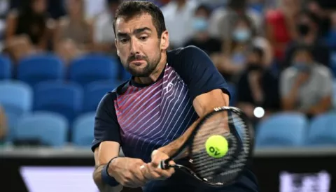 epa09701725 Marin Cilic of Croatia plays a shot during his third round match against Andrey Rublev of Russia on Day 6 of the Australian Open, at Melbourne Park, in Melbourne, Australia, 22 January 2022. EPA/DEAN LEWINS AUSTRALIA AND NEW ZEALAND OUT