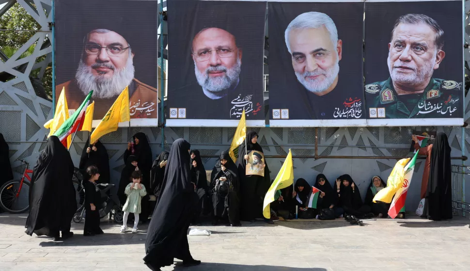 epaselect epa11637756 Iranian women clad in black chadors gather near banners depicting (L-R) late Hezbollah leader Hasan Nasrallah, late Iranian President Ebrahim Raisi, late IRGC Lieutenant general and commander of the Quds Force Qasem Soleimani and late IRGC brigadier general Abbas Nilforoushan during an anti-Israeli rally after Iran launched a missile attack against Israel the previous night, in Imam Hussein Square in Tehran, Iran, 02 October 2024. Iran has launched dozens of missiles directed at Israel on 01 October 2024, state media reported quoting the Islamic Revolutionary Guard Corps (IRGC). The attack was a 'retaliation for different assassinations' carried out by Israel and 'the crimes in Palestine and Lebanon', IRGC said. According to the Israeli army, more than 180 ballistic missiles were fired against Israel from Iran. EPA/ABEDIN TAHERKENAREH